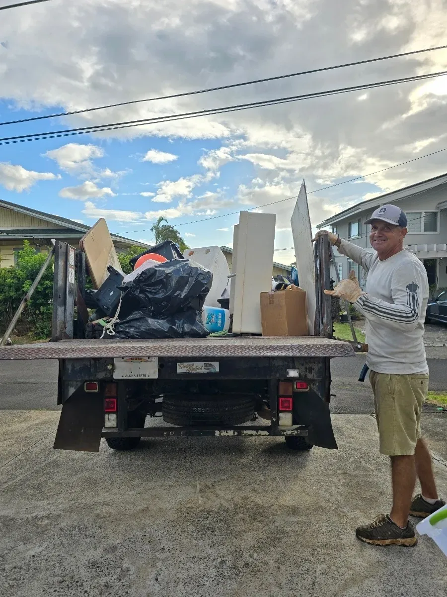 JunkForce team and company vehicle loaded with garbage